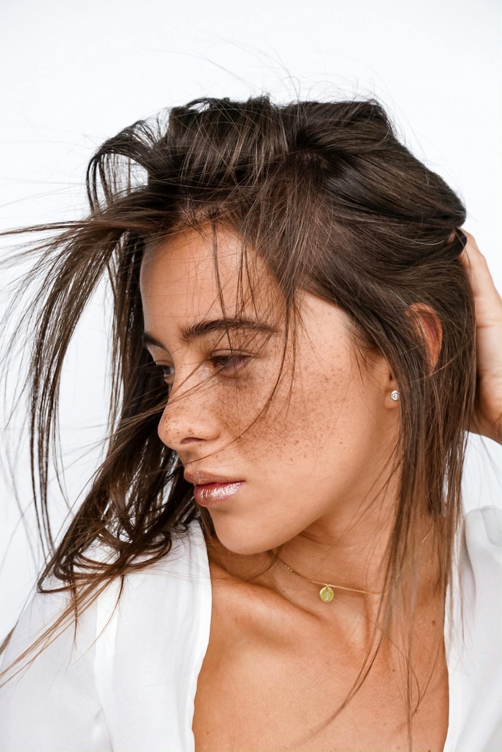 Intimate close-up portrait capturing a woman's natural beauty and striking freckles.